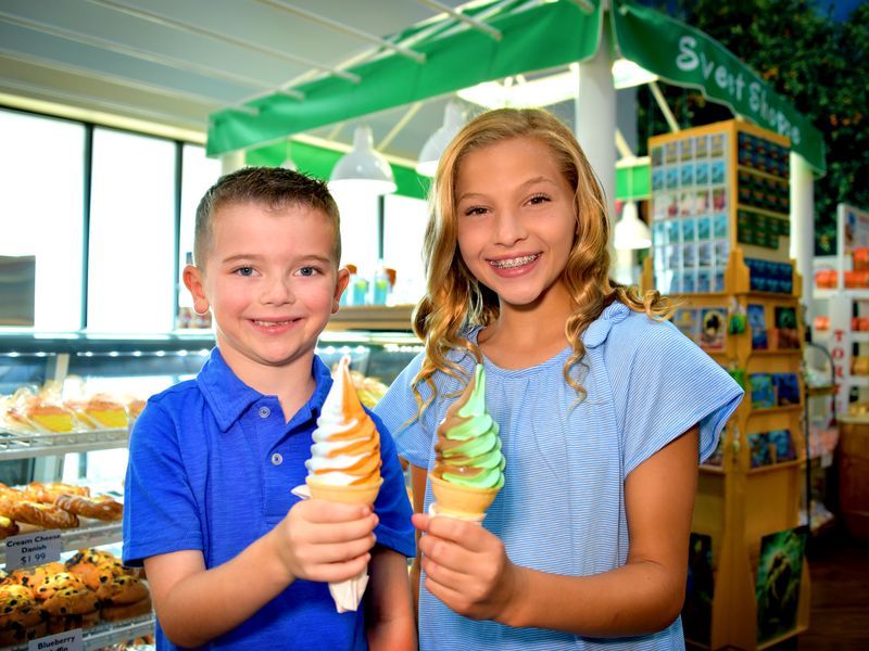 Kids enjoying soft serve ice cream cones at Sun Harvest Citrus
