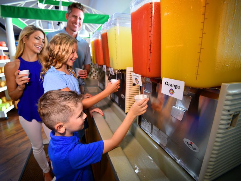 Family enjoying fresh juice at the Sun Harvest Citrus juice bar